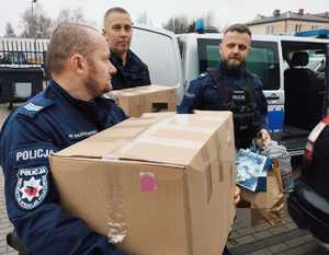 obraz przedstawia policjantów z paczkami świątecznymi
