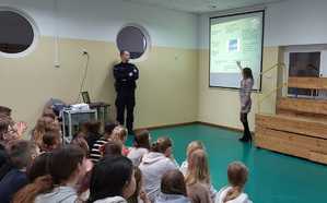 obraz przedstawia policjanta na spotkaniu z dziećmi