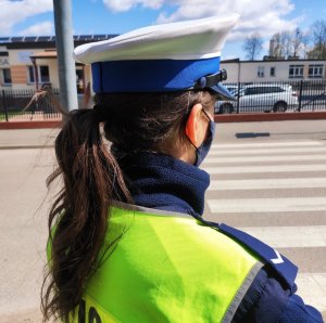 obraz przedstawia policjantkę W tle budynek szkoły w Ciechanowcu