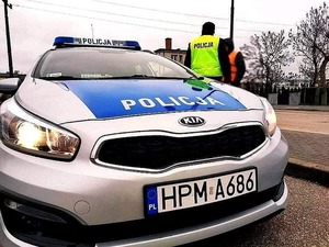 obraz przedstawia policjanta obserwującego przejście dla pieszych