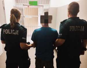 obraz przedstawia dwóch policjantów trzymających poszukiwanego